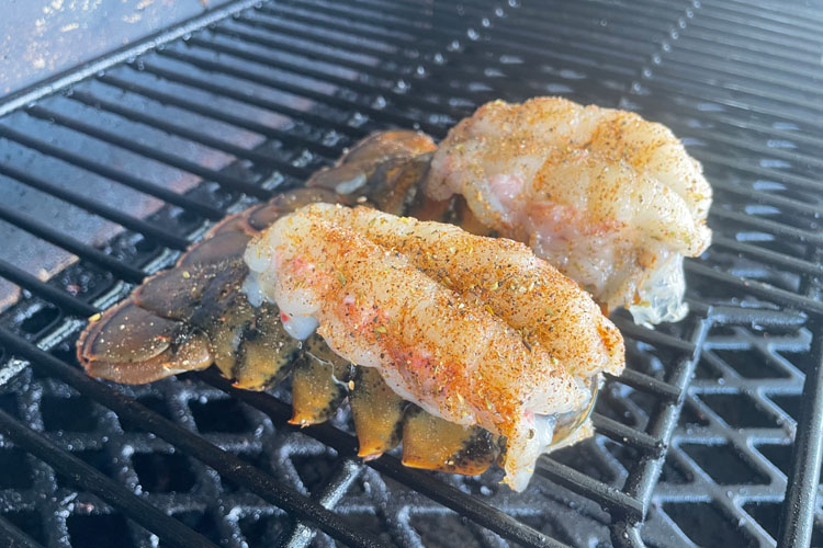 raw seasoned lobster on the grill