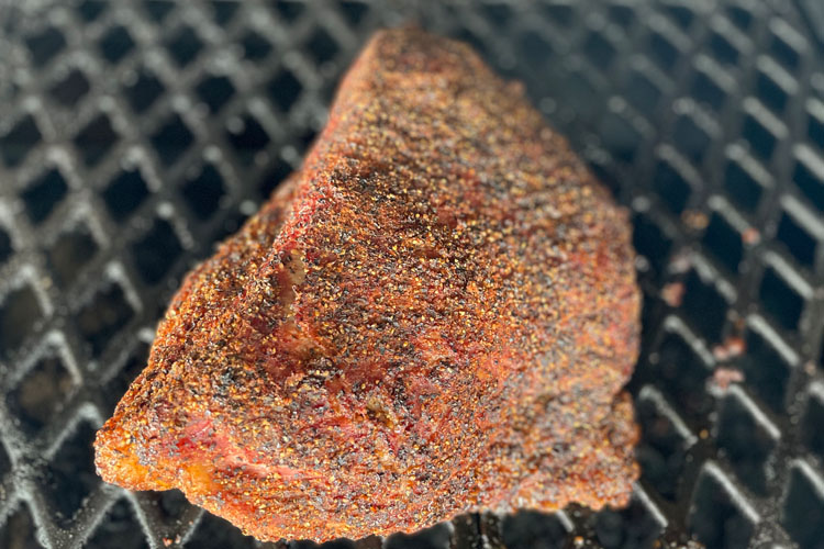 seasoned smoked pastrami on the grill