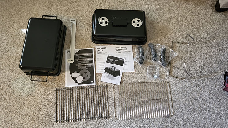 unassembled pieces of weber go-anywhere grill on the floor