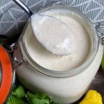 jar of alabama white sauce with spoon in it