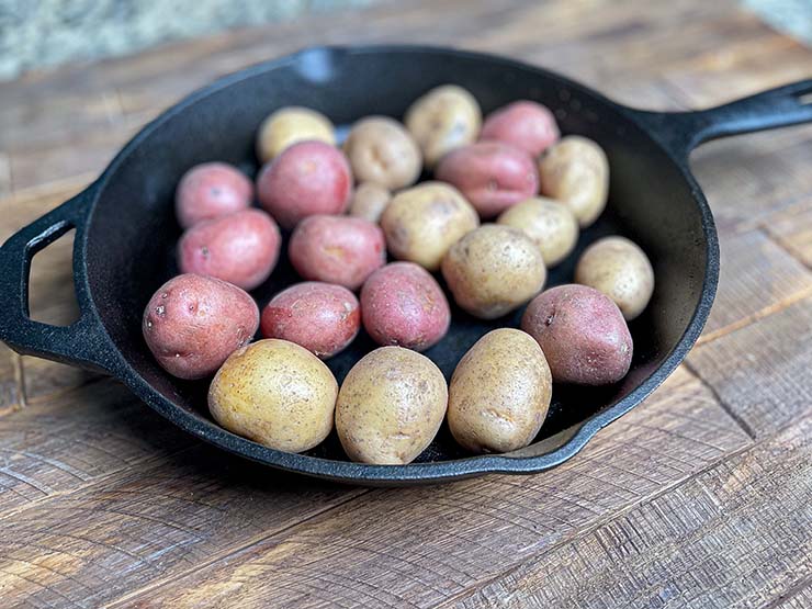 uncooked baby potatoes in a cast iron skillet