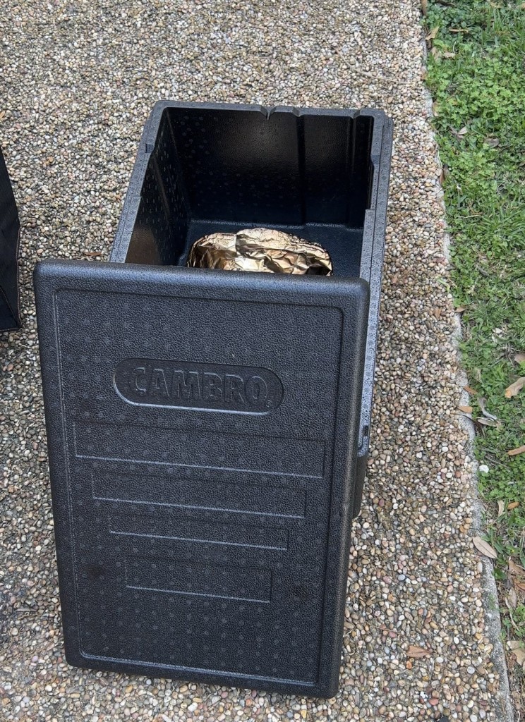 cambro with lid off and aluminum foil package inside