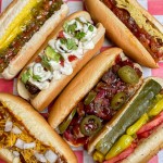 6 differant hotdogs on red checked napkin