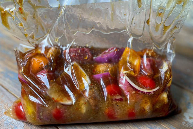 meat and veges in a plastic bag full of marinade