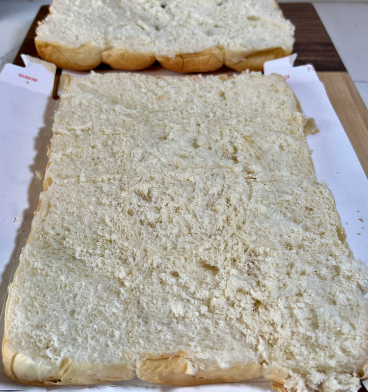 slab of slider buns cut in half of on white board
