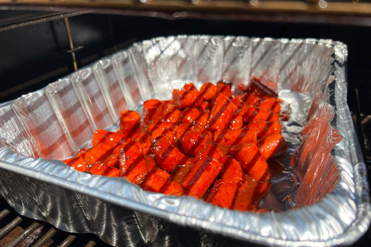 franks and sauce in an aluminum tray