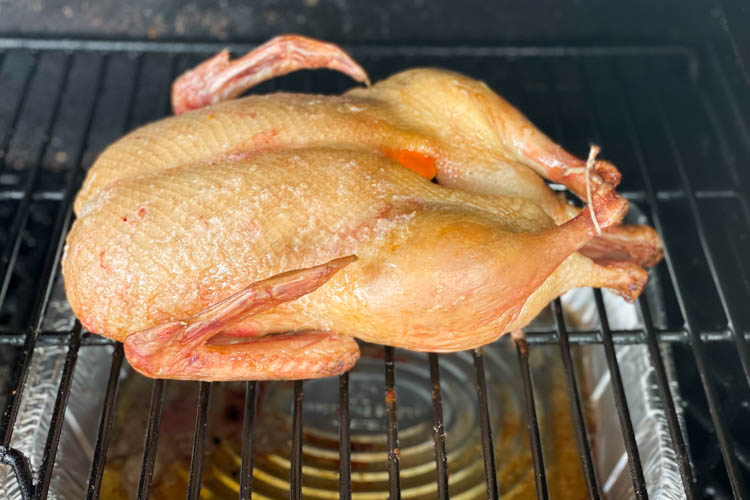 cooked duck on grill in smoker