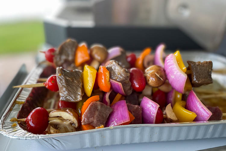raw kebobs on metal tray