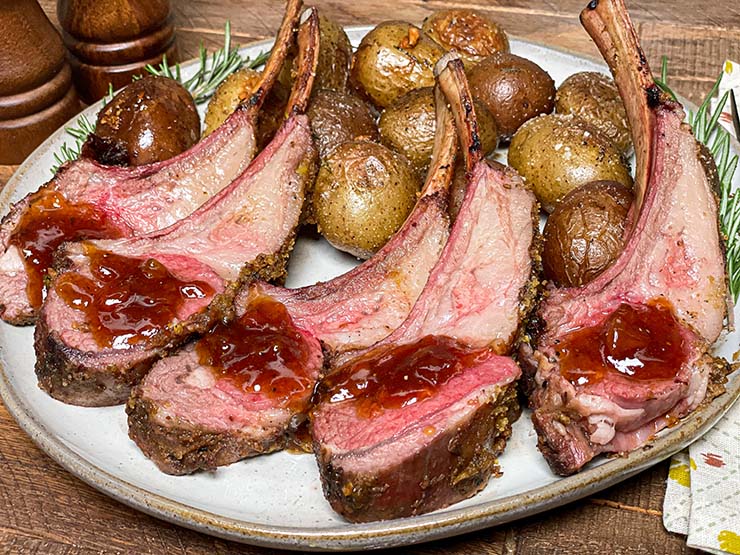 smoked rack of lamb cut into individual chops served with potatoes and apricot-balsamic sauce