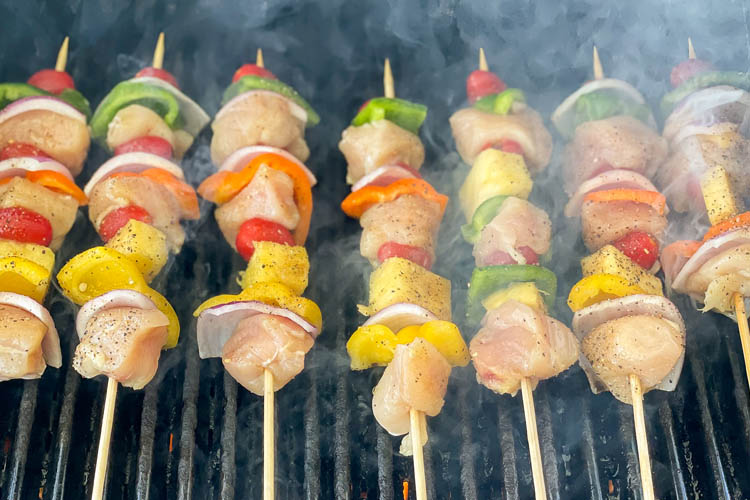 chicken kebobs cooking on the grill