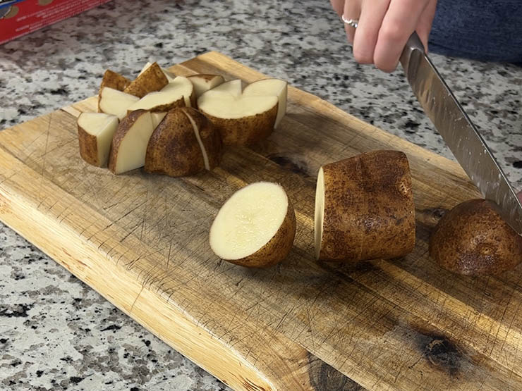 chopped russet potatoes on a wooden board