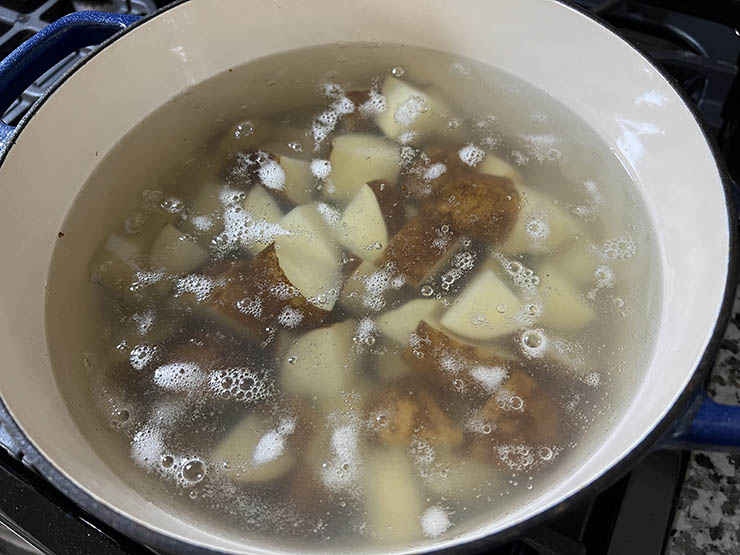 chopped russet potatoes boiling in a pan