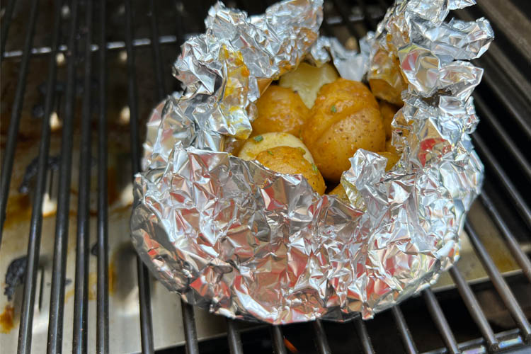 potatoes in a foil boat on the grill