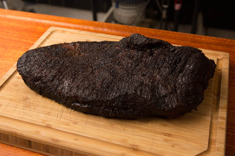 smoked brisket on a wooden chopping board