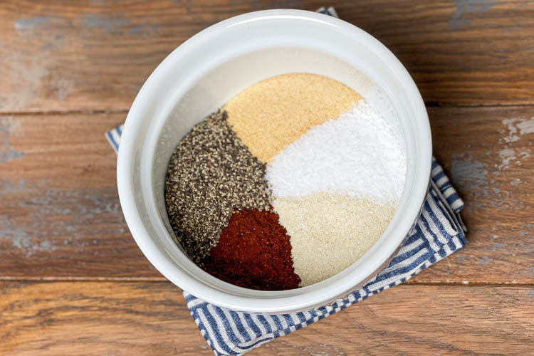 rub ingredients in a white bowl  before mixing