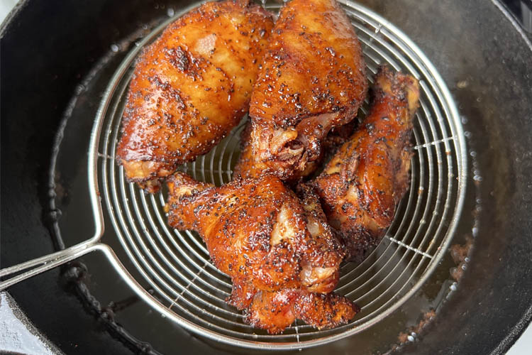 smoked wings on a spider strainer