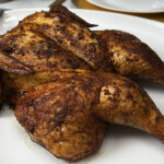 whole smoked pellet grill chicken on plate