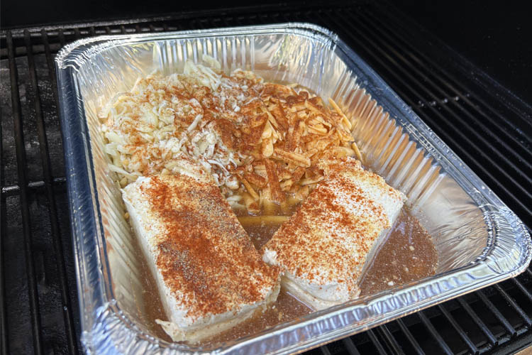 beer cheese ingredients in an aluminum tray on the smoker