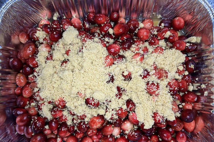 cranberries in aluminum tray with yellow juicer 