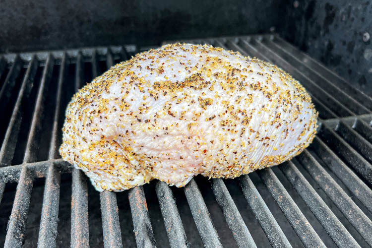seasoned turkey breast on the grill