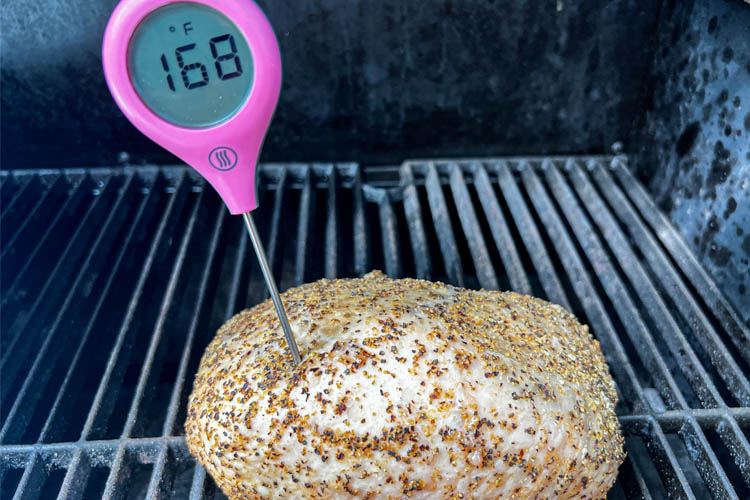 turkey breast on the grill with temperature probe sticking out reading 168