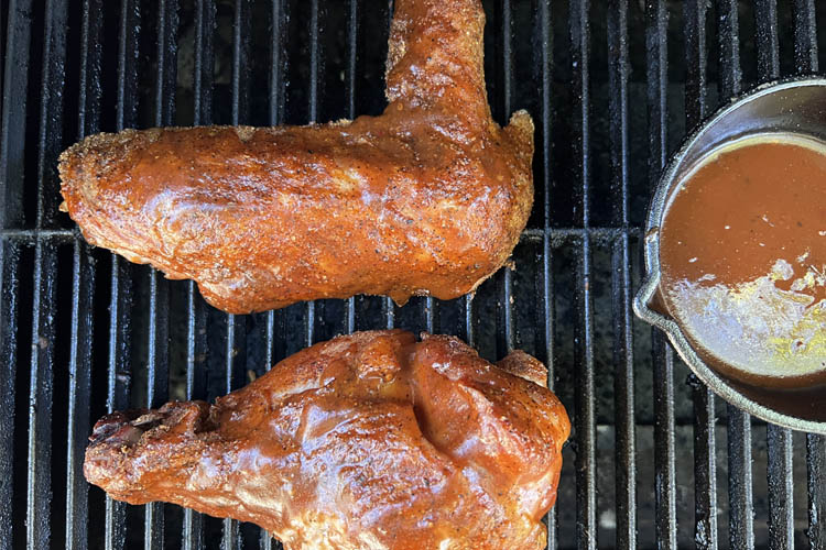 cooked and basted turkey wings on the grill