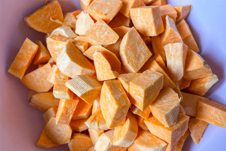 uncooked peel and cubed sweet potato in a bowl