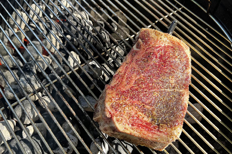 New York Strip steak on a charcoal grill