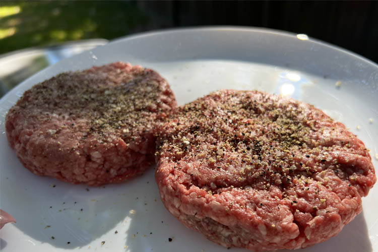 raw bison patties on a white plate
