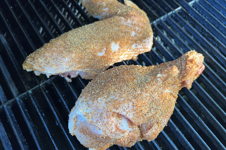 raw seasoned turkey wings on the grill