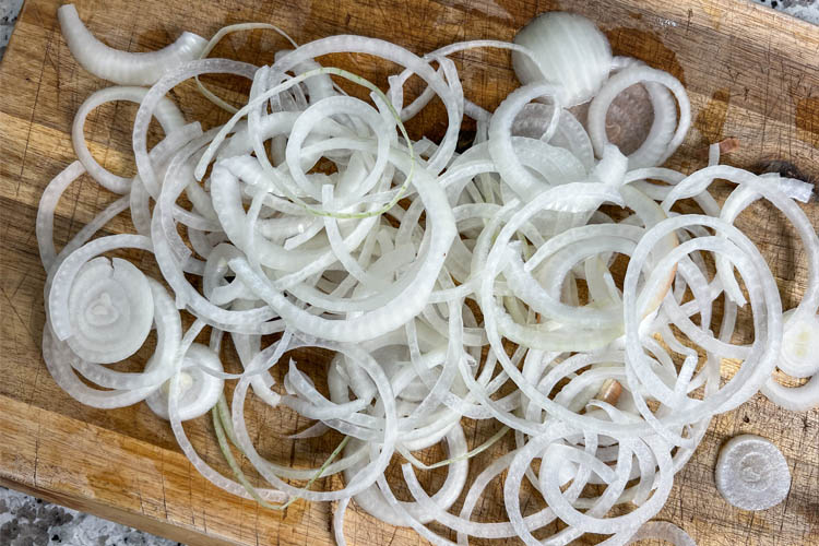sliced onion on a wooden chopping board