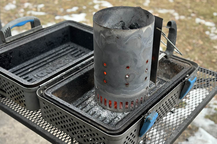 lit chimney starter sitting on grill