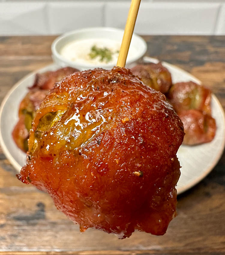a bacon wrapped brussels sprout on a toothpick