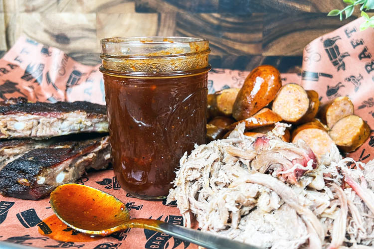 Kansas city bbq sauce in a jar with meat around it
