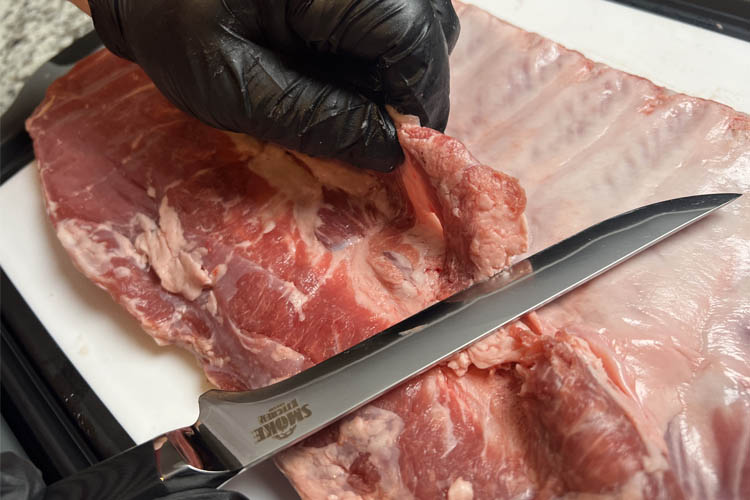 knife trimming pork ribs