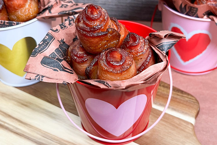 a bucket with a heart on it filled with bacon roses