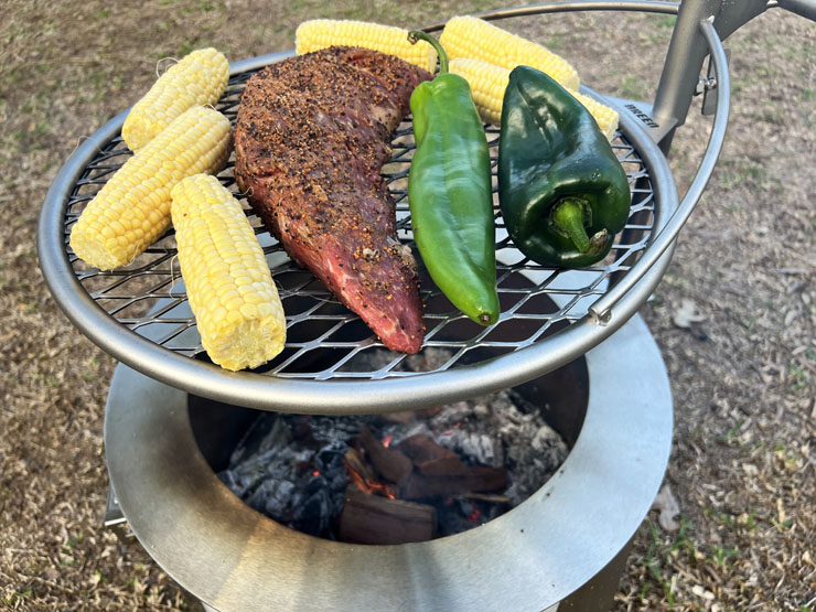 meat and veggies grilling on the Breeo Y Series fire pit
