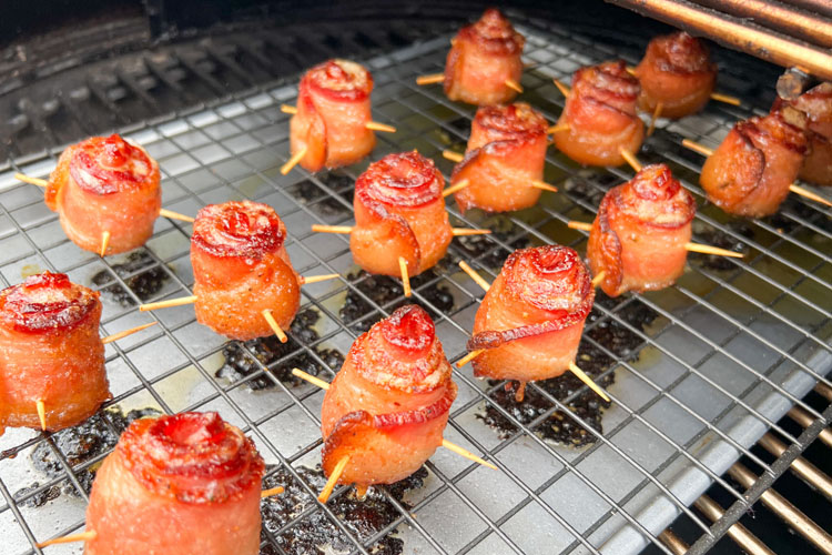a rack of cooked bacon roses in the smoker
