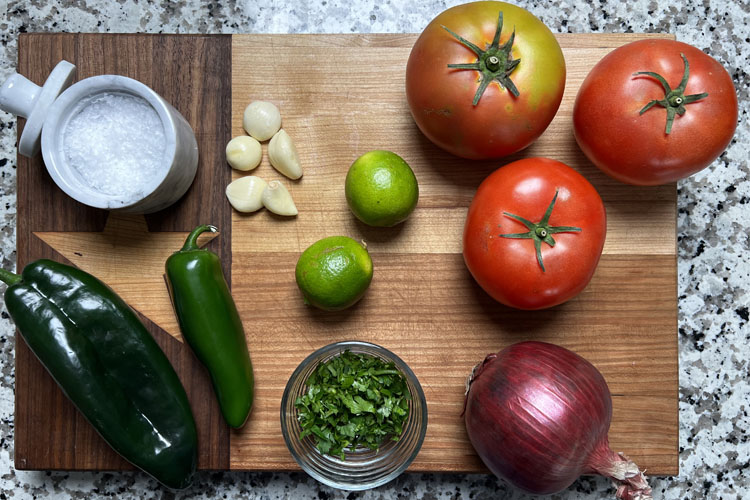 Ingredients for smoked salsa on a wooden chopping board