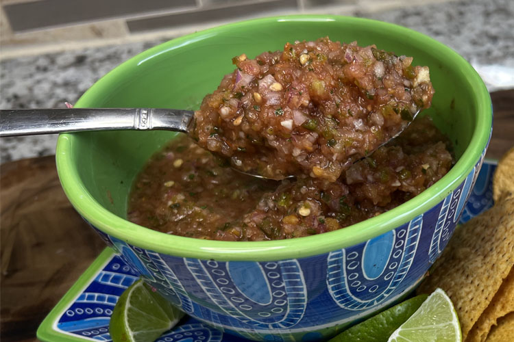 salsa in a bowl with a spoon