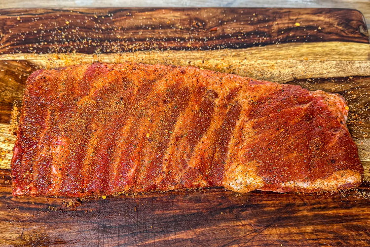 seasoned pork rib on a wooden chopping board