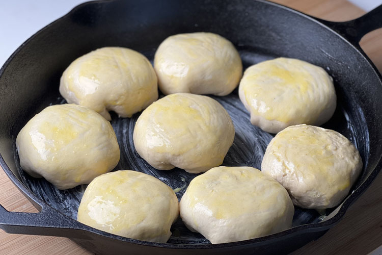 buttered biscuits in a buttered skillet