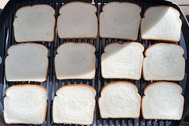 white bread laid out on the grill, uncooked