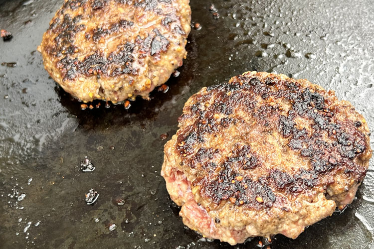 cooked brisket patties on grill