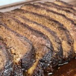 sliced smoked brisket cooked in an electric smoker