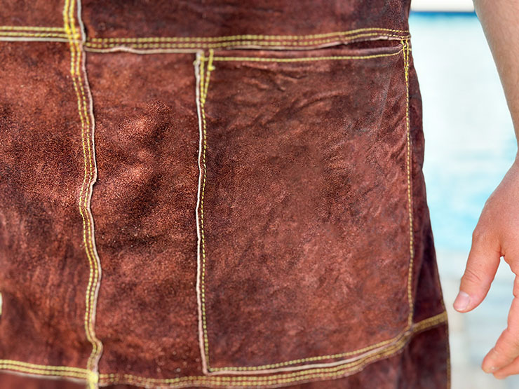 a close up of a leather bbq apron