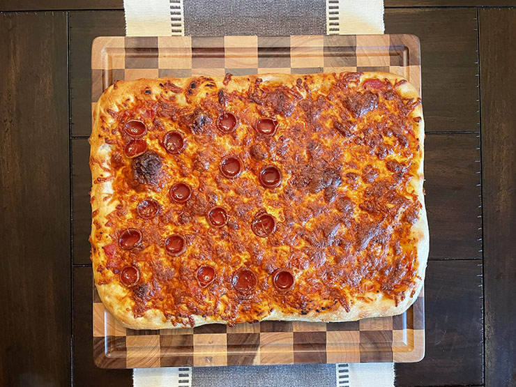 pepperoni pizza on a wooden board
