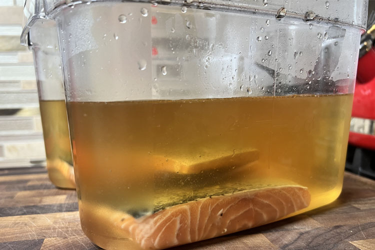 salmon in a container of brine