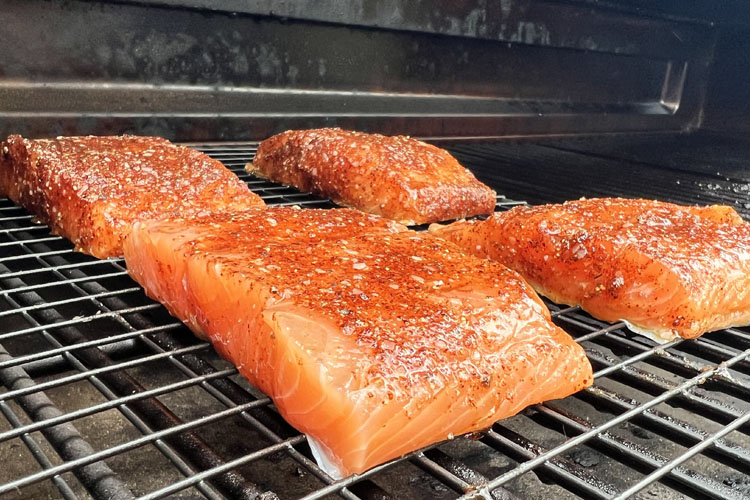 raw salmon fillets in the grill