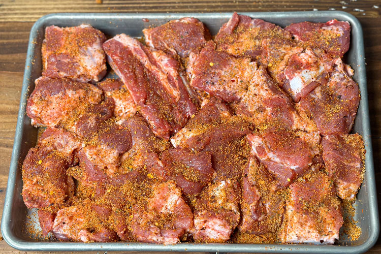 raw seasoned rib tips in metal tray